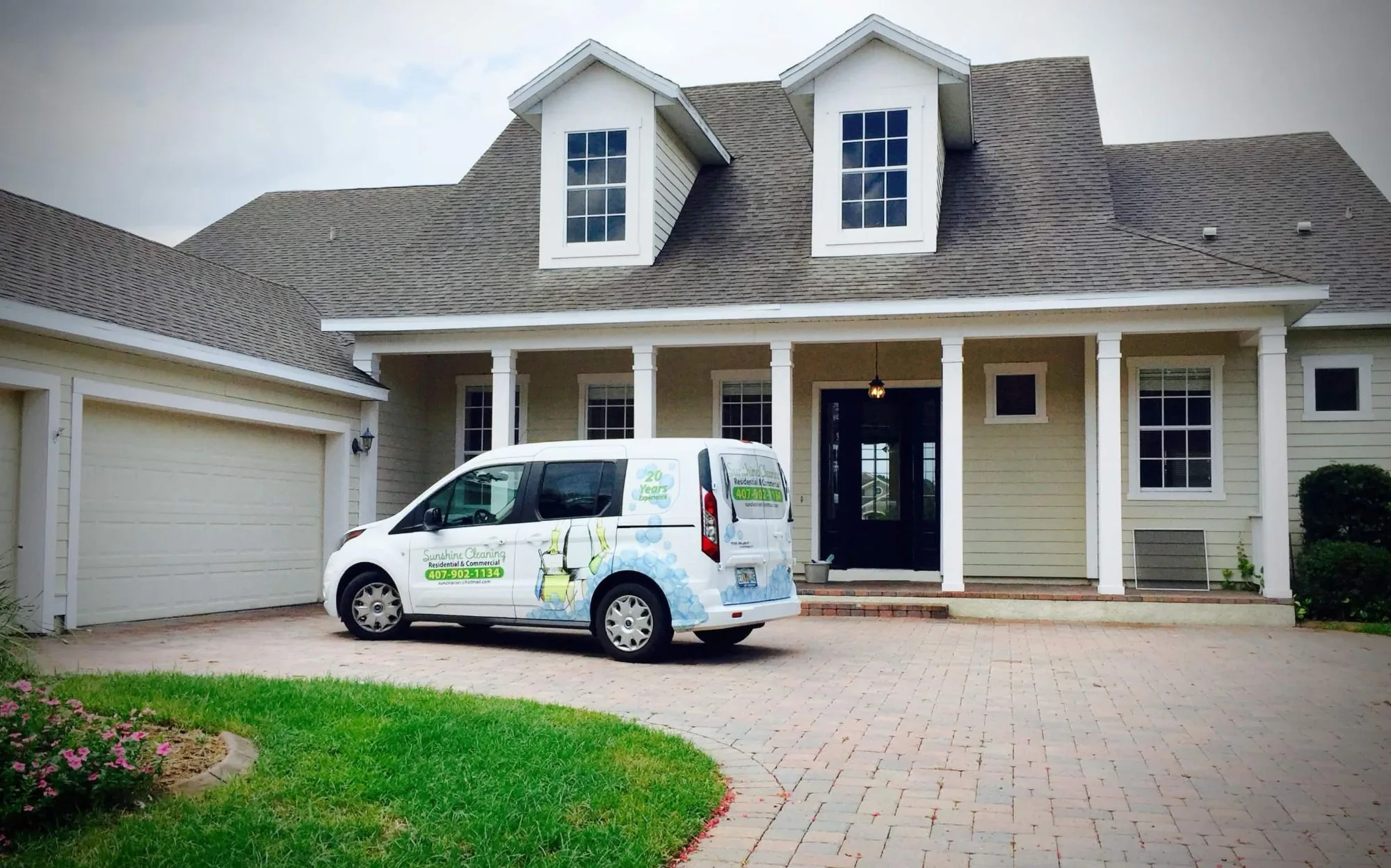 The FL Sunshine Cleaning van parked in the driveway of a freshly cleaned Orlando home